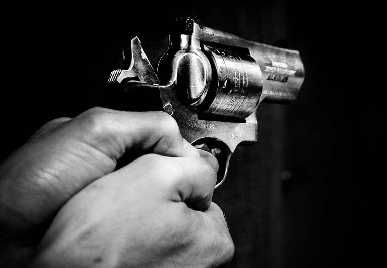 Someone is pointing a revolver in the dark.