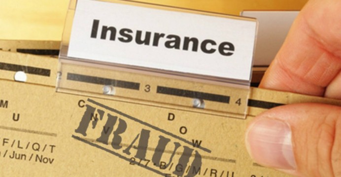 A concept illustration for insurance fraud, showing a business folder stamped with the word "FRAUD".
