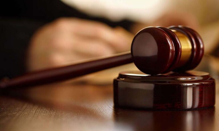a stock photo of a wooden gavel and sound block, commonly used to represent the legal system, courts, or judiciary.