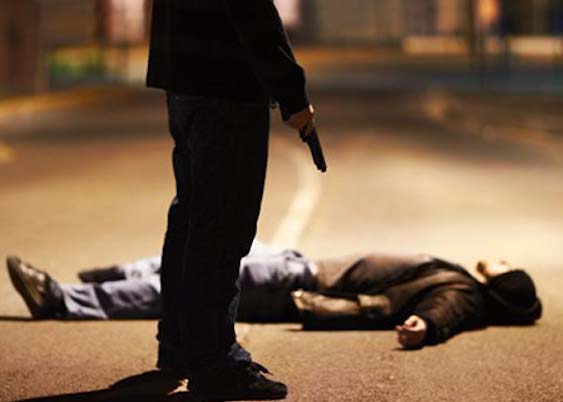 A man lying on the ground after being shot by a gun-wielding criminal.